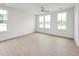 Well-lit bedroom with hardwood floors, neutral walls, and large windows offering natural light at 810 Barlow Dr, Knightdale, NC 27545