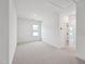 Carpeted bedroom with white walls, window and overhead lighting at 810 Barlow Dr, Knightdale, NC 27545