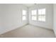 Bedroom with white walls, carpet and large windows at 810 Barlow Dr, Knightdale, NC 27545