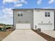 Modern townhome with white and gray siding, two-car garage, and concrete driveway at 810 Barlow Dr, Knightdale, NC 27545