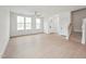 Bright living room features a ceiling fan, white walls, wood-look floors, and plenty of natural light from large windows at 810 Barlow Dr, Knightdale, NC 27545