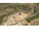 Expansive aerial view showcasing the property's layout, surrounded by natural landscape and adjacent homes at 8624 Dukes Lake Rd, Zebulon, NC 27597