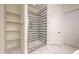Bathroom featuring a spacious walk-in shower with striped tile, storage shelves and a glass door at 8624 Dukes Lake Rd, Zebulon, NC 27597
