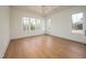 Well lit bedroom with trey ceiling and large windows at 8624 Dukes Lake Rd, Zebulon, NC 27597