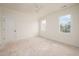 Bright bedroom featuring neutral walls, ceiling fan, and two windows offering ample natural light at 8624 Dukes Lake Rd, Zebulon, NC 27597