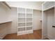 Walk-in closet with custom shelving and rod storage solutions, plus hardwood floors at 8624 Dukes Lake Rd, Zebulon, NC 27597