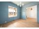 Light blue dining room with trimwork and view into entry at 8624 Dukes Lake Rd, Zebulon, NC 27597