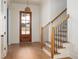 Charming entryway with natural light and wooden staircase at 8624 Dukes Lake Rd, Zebulon, NC 27597