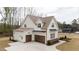 Spacious three-car garage, with an expansive driveway, offering ample parking and storage at 8624 Dukes Lake Rd, Zebulon, NC 27597