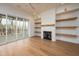 Bright living room with sliding glass doors and fireplace with built-in shelving at 8624 Dukes Lake Rd, Zebulon, NC 27597
