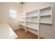 Spacious pantry features shelving, and wood floors at 8624 Dukes Lake Rd, Zebulon, NC 27597
