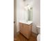 Cozy half bathroom with a wooden vanity cabinet and quartz countertop at 8624 Dukes Lake Rd, Zebulon, NC 27597