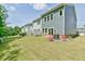 View of a beautifully maintained backyard and the back of a home with double doors leading to the lawn at 140 Norwell Ln, Pittsboro, NC 27312