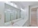 Elegant bathroom with dual sinks, quartz countertop, a large mirror, and a walk-in shower at 140 Norwell Ln, Pittsboro, NC 27312