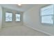 Bright bedroom with neutral carpet and multiple windows that offer ample natural light at 140 Norwell Ln, Pittsboro, NC 27312