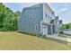 Stylish exterior of townhome with blue siding, stone accents, and a well-manicured lawn at 140 Norwell Ln, Pittsboro, NC 27312
