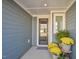 Cozy front porch with a decorative door, potted plants and a side window for natural light at 140 Norwell Ln, Pittsboro, NC 27312