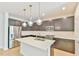 Modern kitchen features stainless steel appliances, a kitchen island, and stylish pendant lighting at 140 Norwell Ln, Pittsboro, NC 27312