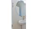 Modern powder room features a round mirror and pedestal sink with sleek gold faucet at 140 Norwell Ln, Pittsboro, NC 27312