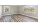 Serene bedroom with hardwood floors, neutral walls, and large windows offering ample natural light at 203 W Stewart St, Coats, NC 27521