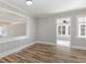 Cozy dining area with hardwood floors, paneled walls, and an open view to another room at 203 W Stewart St, Coats, NC 27521
