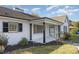 Welcoming front porch with black columns and shutters, complemented by manicured landscaping at 203 W Stewart St, Coats, NC 27521