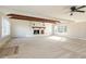 Spacious living area featuring exposed beams, a brick fireplace, and large windows for natural light at 203 W Stewart St, Coats, NC 27521
