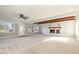 Bright, open living room with wood beam features, a brick fireplace, and large windows at 203 W Stewart St, Coats, NC 27521