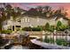 Home with expansive deck and pool, nestled in a wooded area at dusk at 110 Bywater Way, Chapel Hill, NC 27516