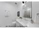 Stylish bathroom with white cabinets, large mirror, and modern fixtures at 1306 Lennox Pl, Raleigh, NC 27612