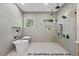 A bathroom features a soaking tub, walk-in shower, tiled walls, and natural lighting at 1306 Lennox Pl, Raleigh, NC 27612