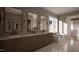 Luxurious bathroom showcasing double vanities, elegant mirrors, marble flooring, and a freestanding tub at 1306 Lennox Pl, Raleigh, NC 27612