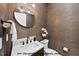 Cozy bathroom with textured wallpaper, round mirror, and decorative lighting at 1306 Lennox Pl, Raleigh, NC 27612