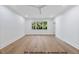 Bright bedroom with hardwood floors, large window, and ceiling fan at 1306 Lennox Pl, Raleigh, NC 27612