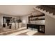 Modern dining area with a bar, under-stair wine storage, and natural light from the sliding glass door at 1306 Lennox Pl, Raleigh, NC 27612