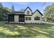 Beautifully designed two-story home with black trim windows and a well-manicured lawn at 1306 Lennox Pl, Raleigh, NC 27612