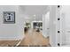 Bright hallway featuring hardwood floors, white walls, and a glimpse into the modern living space at 1306 Lennox Pl, Raleigh, NC 27612