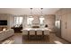 Modern kitchen featuring an oversized island with seating, stainless steel appliances, and brick fireplace in background at 1306 Lennox Pl, Raleigh, NC 27612
