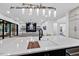 Stylish kitchen island with a sink, butcher block accent, seating, and an open view of the living room at 1306 Lennox Pl, Raleigh, NC 27612