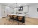 Modern kitchen featuring a large island with seating, pendant lighting, and white cabinets at 1306 Lennox Pl, Raleigh, NC 27612