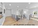 Bright landing with hardwood floors and modern railing at 1306 Lennox Pl, Raleigh, NC 27612