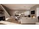 Stylish living room showcases modern furnishings, a fireplace with a TV, and an open staircase at 1306 Lennox Pl, Raleigh, NC 27612