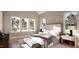 Bright and airy main bedroom featuring large windows, neutral tones, and an inviting upholstered bed frame at 1306 Lennox Pl, Raleigh, NC 27612