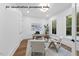 Well-lit office space with modern decor, including a desk, seating, and ample natural light from the windows at 1306 Lennox Pl, Raleigh, NC 27612