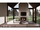 Inviting screened porch with a fireplace, comfortable seating, and a beautiful outdoor view at 1306 Lennox Pl, Raleigh, NC 27612