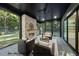 Charming sunroom with stone fireplace, ample seating, and backyard views at 1306 Lennox Pl, Raleigh, NC 27612
