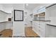 A walk-in closet features custom shelving, drawers, and hardwood floors at 1306 Lennox Pl, Raleigh, NC 27612