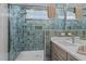 Bathroom boasts a glass walk-in shower with blue tile surround, a window, and a single vanity at 25 Basil Ct, Franklinton, NC 27525