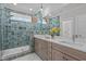 The bathroom features double vanity sinks, a large mirror, and a walk-in shower with blue tiled walls at 25 Basil Ct, Franklinton, NC 27525