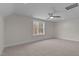 This carpeted bedroom features a ceiling fan, a window, and white walls at 25 Basil Ct, Franklinton, NC 27525
